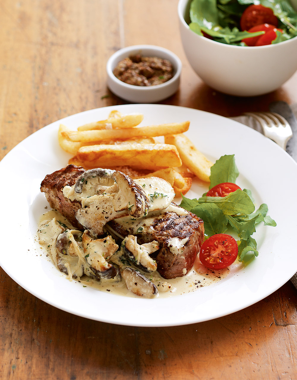 Creamy mushroom sauce with barbecue steaks