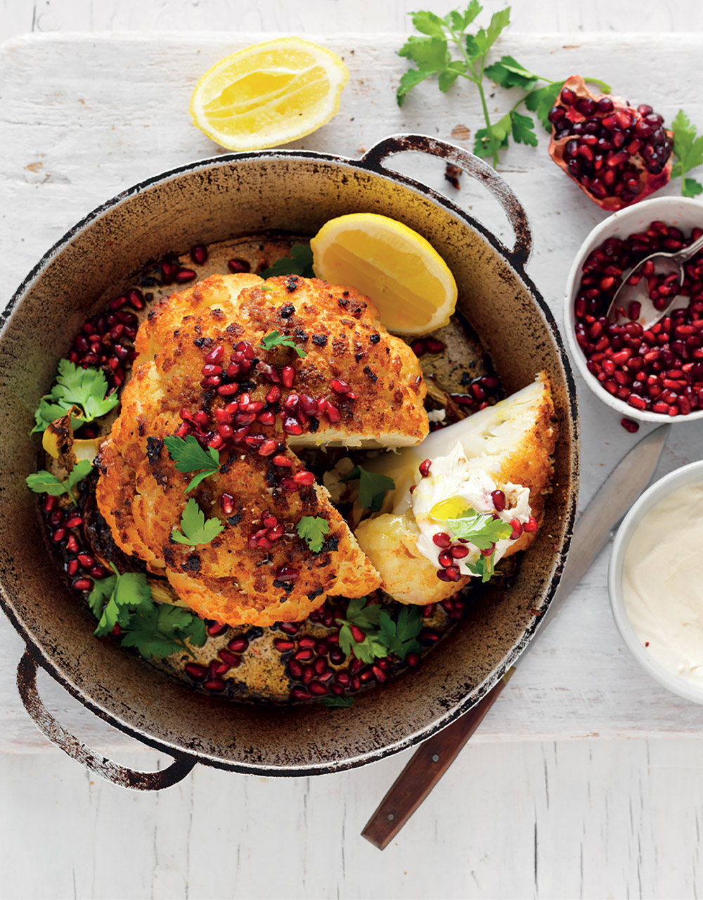 Whole roasted spiced cauliflower with tahini yoghurt & pomegranate